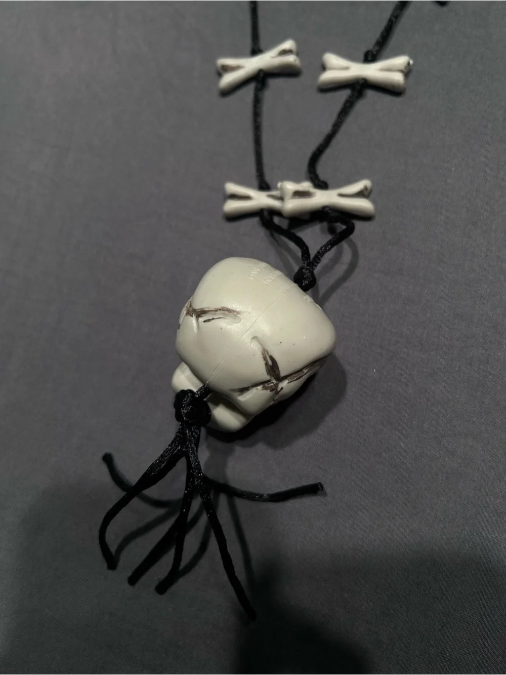 Greenbrier International Plastic Skull and Crossbones Cord Necklace